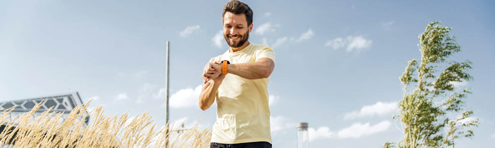 Man running outside and checking his watch Man running outside and checking his watch